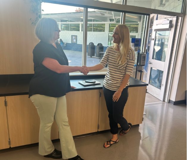 The principal, Jessica Romero, shakes hands with Elizabeth Bjorklund in her classroom (Photo By: Beatrice Aharonian).